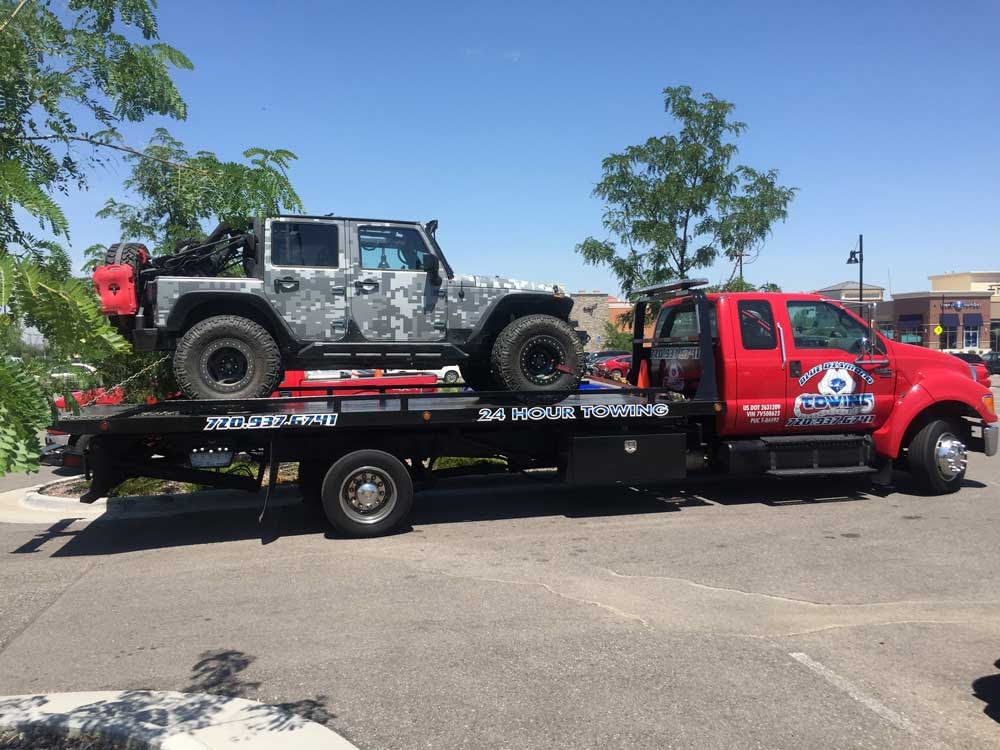 jeep on flat bed truck